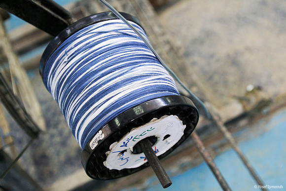 Spindle of Techelet and White Thread on Cutting Frame 2