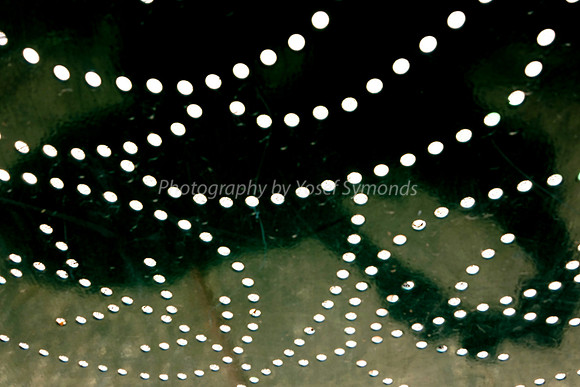 Swirl Holes in Iron Fence 1