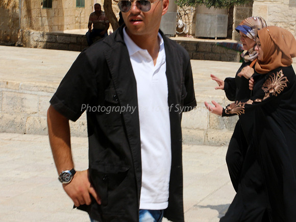 Two Arab Ladies Walking Behind Wakf Guard