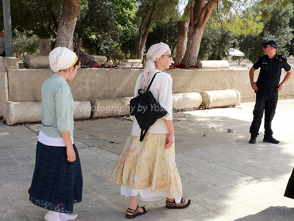 Visitors Passing Ancient Broken Columns