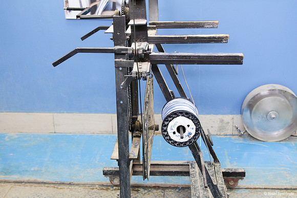 Spindle of Techelet and White Thread on Cutting Frame 7