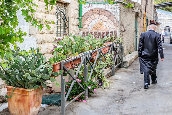 Man Walking Down Narrow Street in Makor Baruch 2