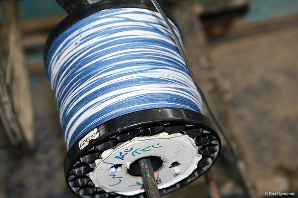 Spindle of Techelet and White Thread on Cutting Frame 1