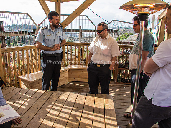 Police Officer in Pleasant Conversation with Jewish Visitors Waiting to Go Up 1