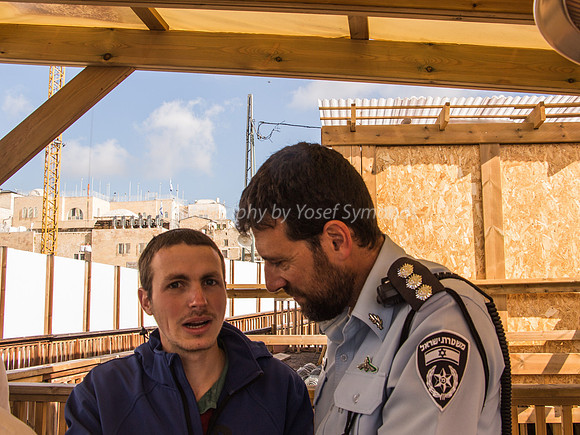Police Officer in Pleasant Conversation with Jewish Visitors Waiting to Go Up 3