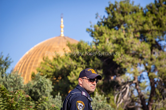 Policeman with Dome of Rock in Background