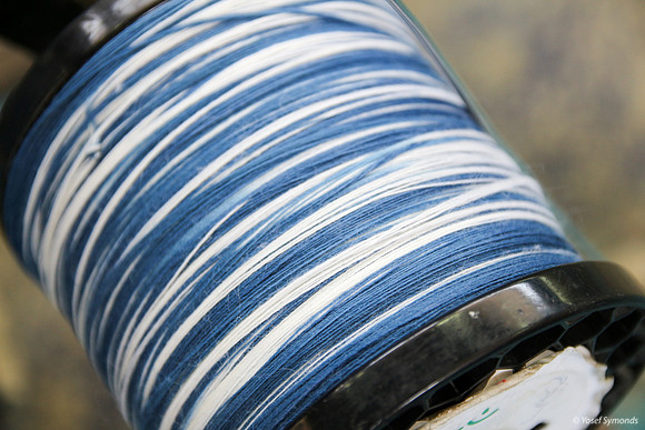 Spindle of Techelet and White Thread on Cutting Frame 4