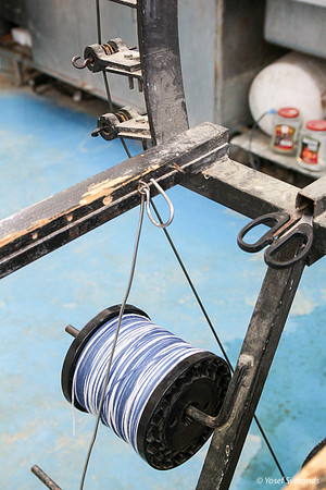 Spindle of Techelet and White Thread on Cutting Frame 6