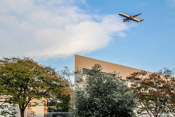 Plane Over Building - Airport City 1