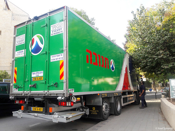 Dairy Supply Truck Delivering on Narrow Street