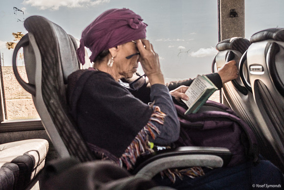 Woman Praying On Bus 250330-1