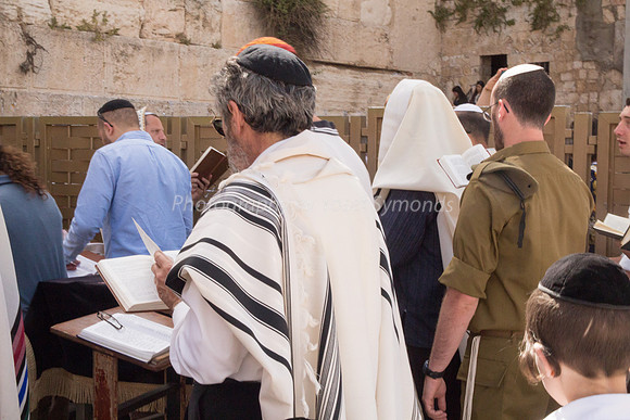 Soldier and Others Praying at Western Wall 1