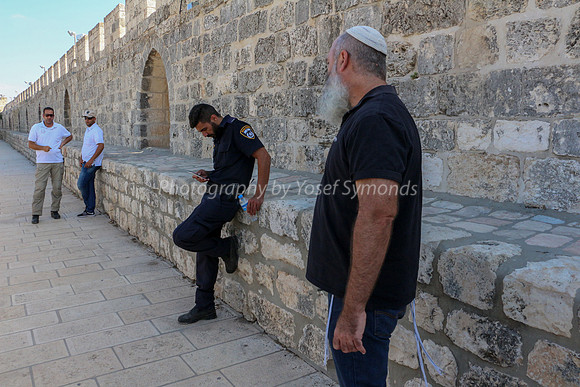 Wakf and Policemen Waiting for Guide to Resume Tour
