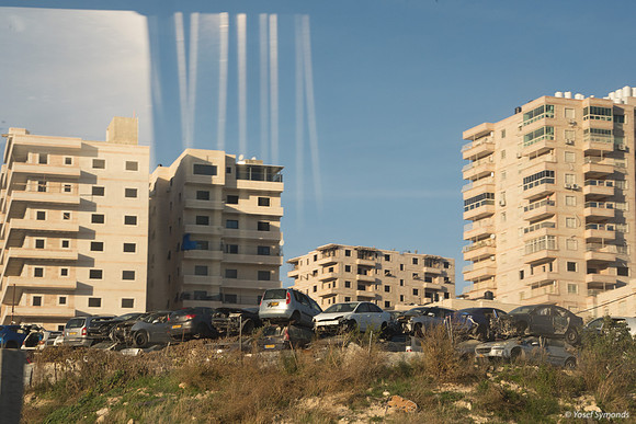 Car Junkyard in Front of Large Modern Arab Buildings East of Jer
