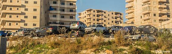 Car Junkyard in Front of Large Modern Arab Buildings East of Jer